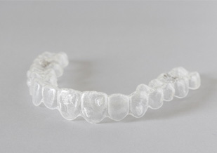 Invisalign clear aligner on grey table