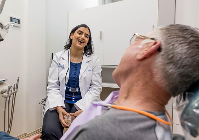 Woman in dental chair giving thumbs up