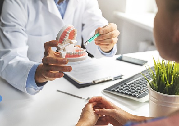 a dentist explaining a dental bridge in Virginia Beach