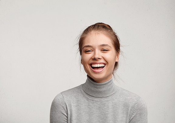 a woman smiling with a dental bridge in Virginia Beach