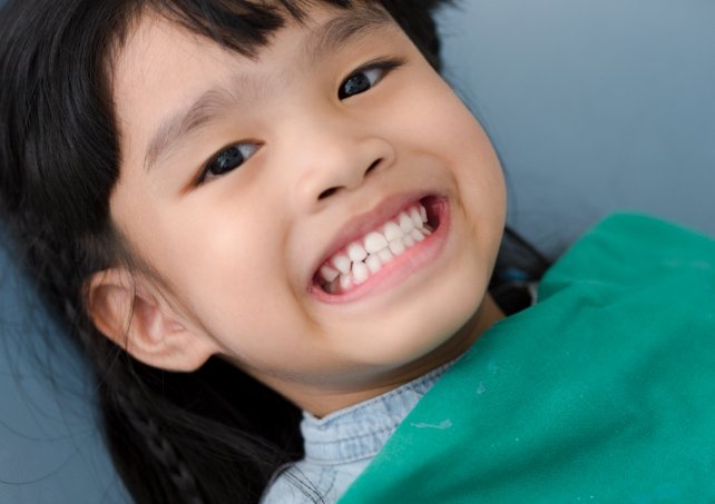 young patient smiling during children's dentistry checkup