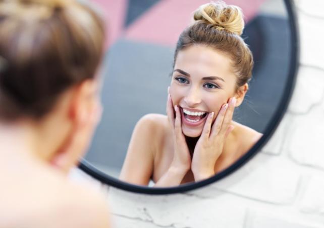 Woman looking at smile after cosmetic dentistry