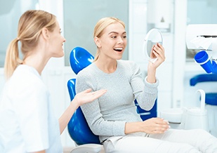 A woman seeing the results of cosmetic dentistry