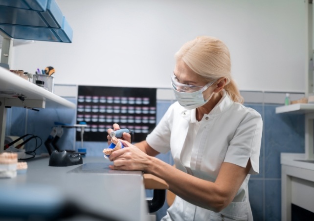 Technician crafting a dental implant supported dental restoration