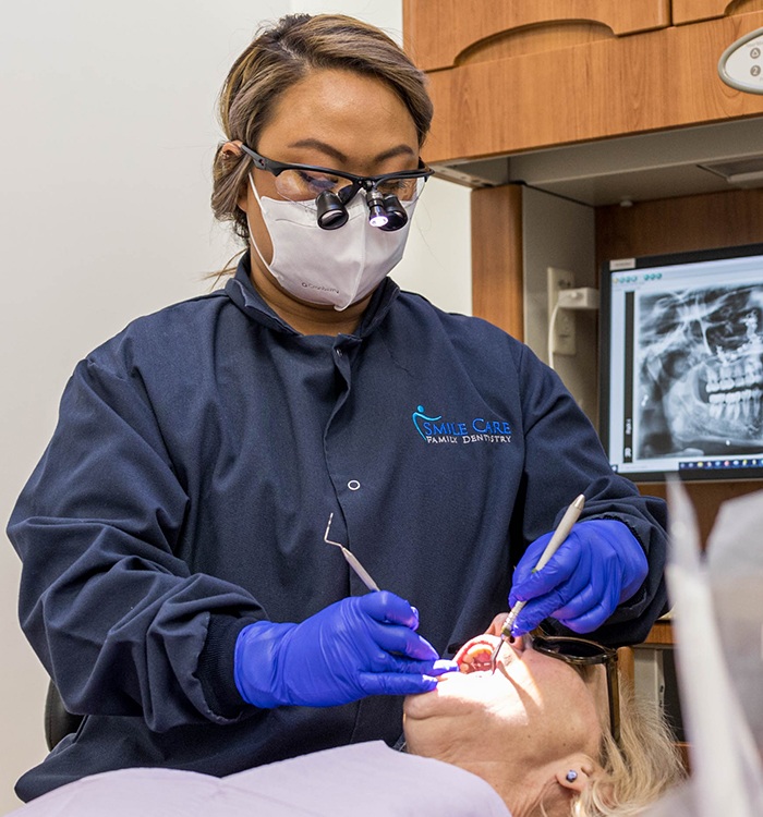 Grandparents and grandchild with healthy smiles after preventive dentistry