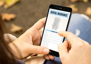 Patient reviewing dental information form on phone outside