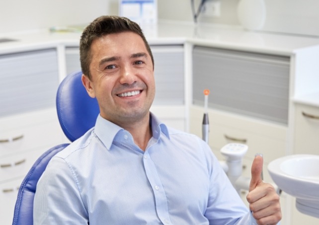 Man giving thumbs up during dental appointment