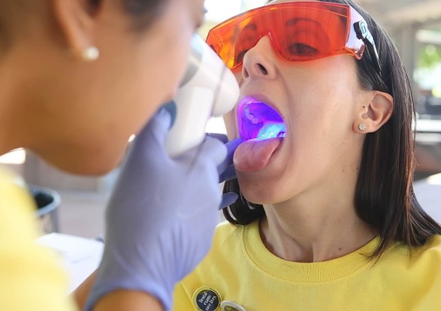 Patient receiving oral cancer screenings