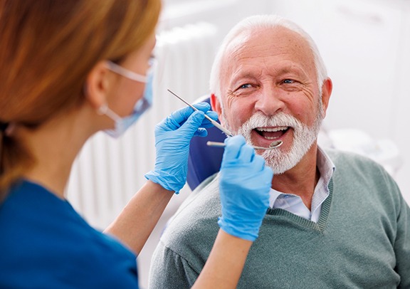 Man smiles at dentist