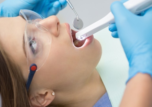 Dentist using intraoral camera to capture smile photos