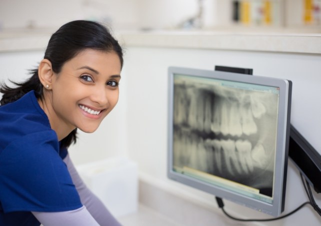 Dental team member reviewing digital x-rays