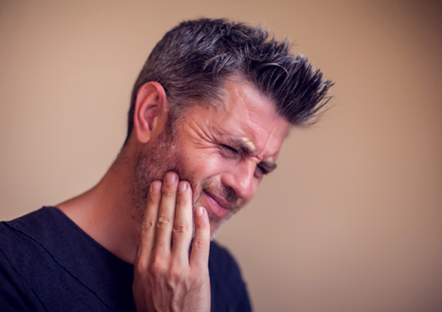 a man suffering from jaw pain