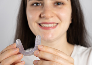 a patient holding an occlusal splint