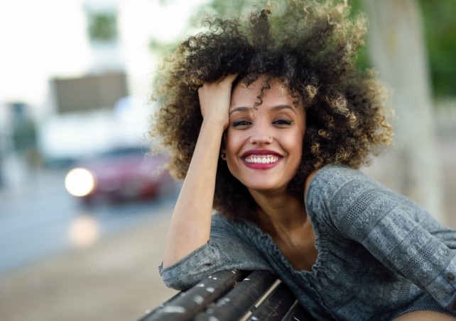 Woman with healthy smile after tooth colored filling restoration