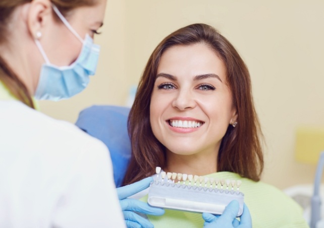 Woman sharing smile after porcelain veneers treatment