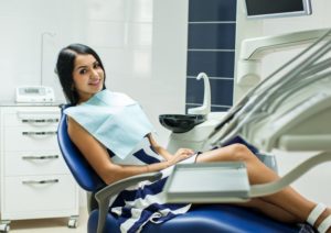 a woman smiling in the dentist’s chair